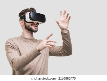 Young man experiencing virtual reality headset, Isolated on gray background. VR, future, gadgets, meta verse, technology, education online, studying, video game concept - Powered by Shutterstock