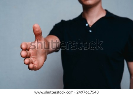 Young Man Extending Hand Toward Camera - Concept of Offering Help or Handshake
