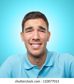 Young Man With A Face Pain Over Light Blue Gradient Background