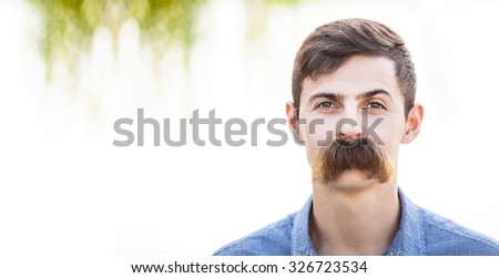 Young man with fake mustaches. Dental health concept.