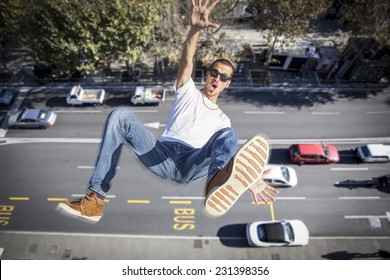 Young Man Falling Down Of A Building