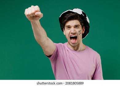 Young Man Fan Wears Basic Pink T-shirt Hat Go Text On Cheek Cheer Up Support Football Sport Team Raised Hand Up Clench Fist Watch Tv Live Stream Scream Isolated On Dark Green Color Background Studio