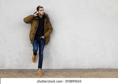 young man to fashion with the cellphone on wall street - Shutterstock ID 593899655