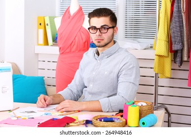 Young Man Fashion Designer In Atelier