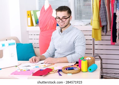 Young Man Fashion Designer In Atelier