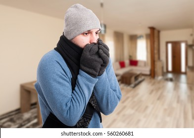 Young Man Feeling Cold And Warming His Hands Inside The House With Text Area