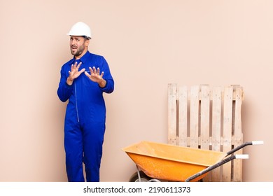 Young Man Feeling Disgusted And Nauseous, Backing Away From Something Nasty, Smelly Or Stinky, Saying Yuck Construction Concept