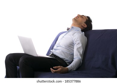 Young Man Fell Asleep On Couch White Working On Laptop Computer. Pure White Background