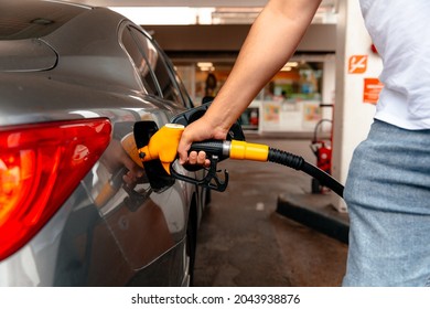 Young man, fill diesel tank of car after finish refill diesel oil and pay price with tax in gas station for transportation of his travel