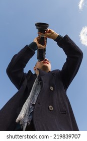 Young Man Filming With A Movie Camera 8 Mm Seen From Below And Sky Background 