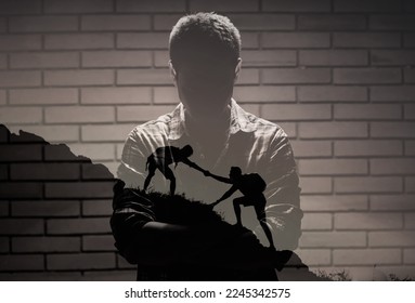 Young man finding courage and mental strength overcoming adversity getting helping hand from a friend reaching out for help dealing with life problems  