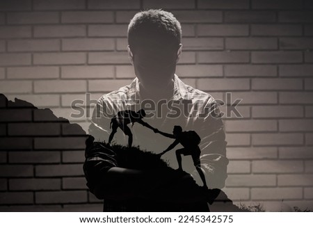 Young man finding courage and mental strength overcoming adversity getting helping hand from a friend reaching out for help dealing with life problems  