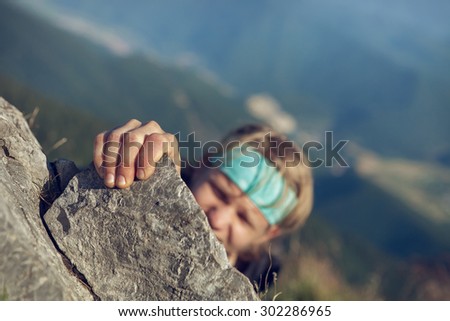 Young man finishing his extreme mountain climb