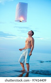 A young man with a fire lantern