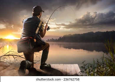 Young man fishing at misty sunrise  - Powered by Shutterstock