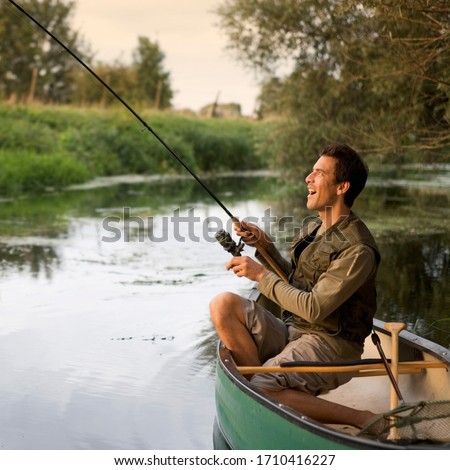 Young man fishing on a beautiful lake