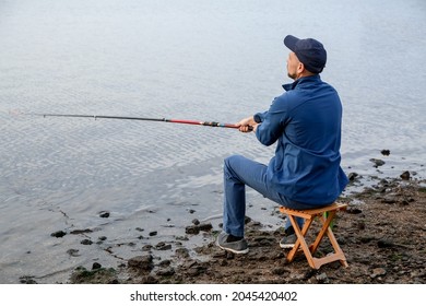 Young Man Fishing On River