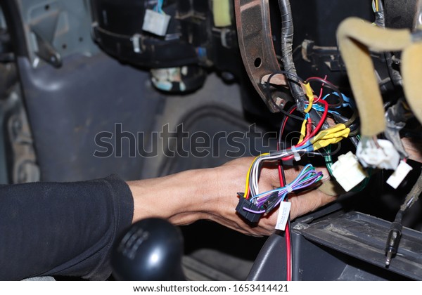 Young man fixing cars, auto mechanic working\
outside repair services