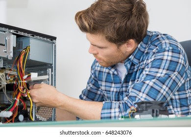 young man fixing computer