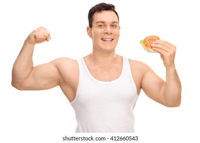 Young Man Flexing His Bicep And Holding A Sandwich In The Other Hand Isolated On White Background