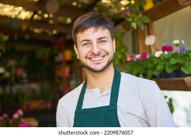 Young Man As Florist And Happy Startup Founder In Flower Shop Or Nursery