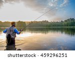 Young man flyfishing at sunrise