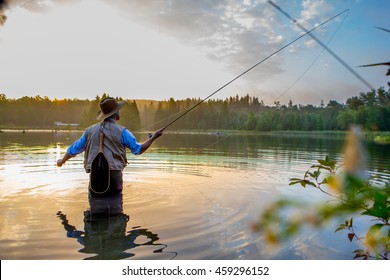 Young man flyfishing at sunrise - Powered by Shutterstock