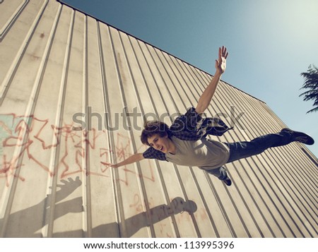 Similar – Image, Stock Photo Happy woman jumping in front of stone wall background