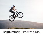 Young man flying through the air on a mountain bike