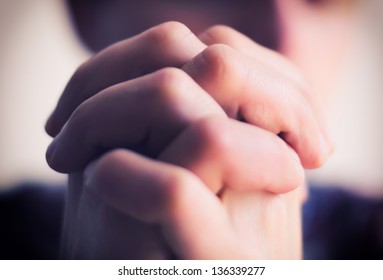 young man folded his hands together