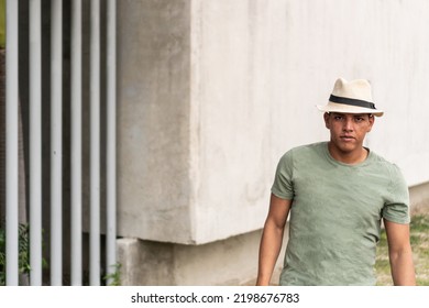 Young Man With Freckles And Dark Hair, Walking Down The Street Looking Around.