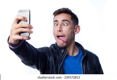 Young Man With Funny Face Taking A Selfie Photo With His Smart Phone
