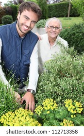 Young Man Gardening With Older Woman