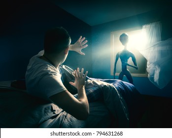 Young man getting abducted by an UFO / high contrast image