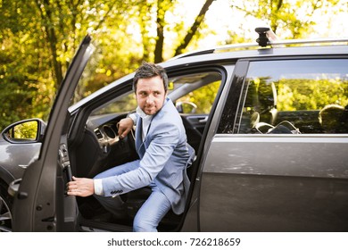 Young Man Getting Into The Car.