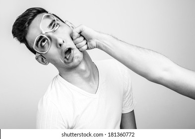 Young Man Getting Punched In The Jaw. Hand Of A Man Hitting In The Face Other Man. Violence And Bulling.