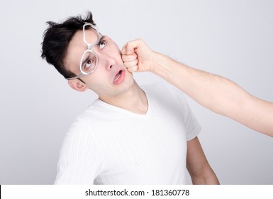 Young Man Getting Punched In The Jaw. Hand Of A Man Hitting In The Face Other Man. Violence And Bulling.