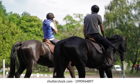 Young man and girl rider brown and black horse in equestrian sport competition.Horse riding on arena.Dressage test.Equestrian competitions,equestrian detour.Two jockeys on horseback sunny summer day - Powered by Shutterstock