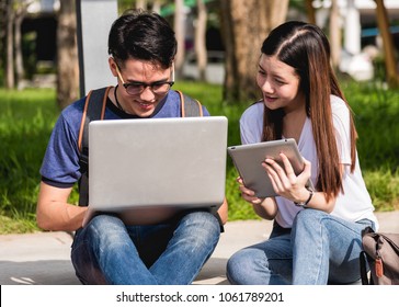 Young Man and girls friend sitting consult on laptop at university together - Shutterstock ID 1061789201