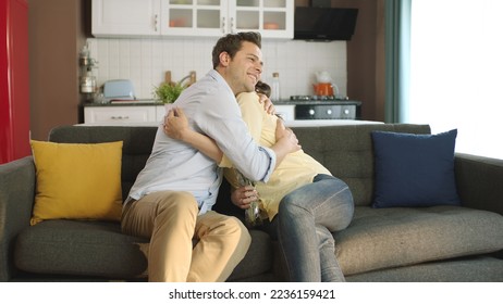 A young man gives his girlfriend a nice gift for Valentine's Day. Young couple happily hugging each other. Marriage proposal. - Powered by Shutterstock