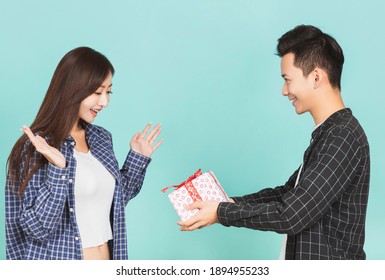 Young Man Giving Present To Beautiful Woman