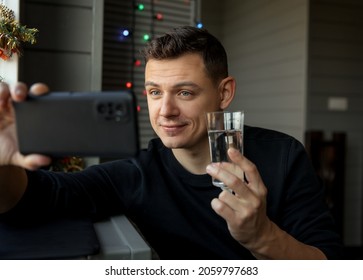 Young Man With Glass Making Facetime Video Calling To Congratulate Merry Christmas His Relatives.