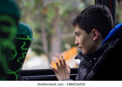 Young Man Goes On A Business Trip Looking Out The Bus Window While Saying Goodbye