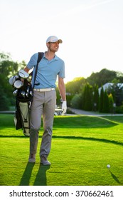 Young man with a golf bag outdoors