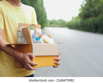 Young Man Hand Holding Box Of Garbage For Recycling. Reuse Reduce Recycle Concept.