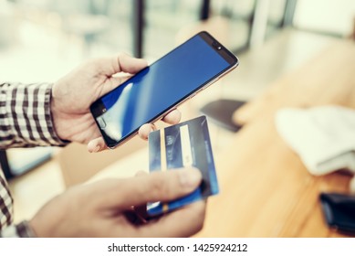 Young man hand holding a credit card and using smart phone for payment online order. Asian people. - Shutterstock ID 1425924212