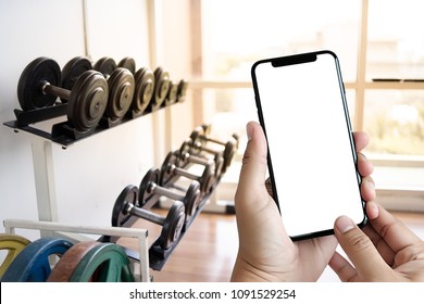 Young Man Hand Holding Smartphone In Gym To  Fitness Phone Fitness Exercise Concept