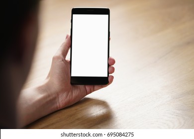 young man hand holding smartphone with blank white screen - Powered by Shutterstock