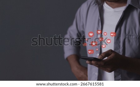 Young man hand Holding, Using smart phone mobile with Love, Follow and Comment Icon to Social Media
