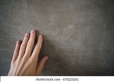 Young Man Hand Touching Concrete Wall